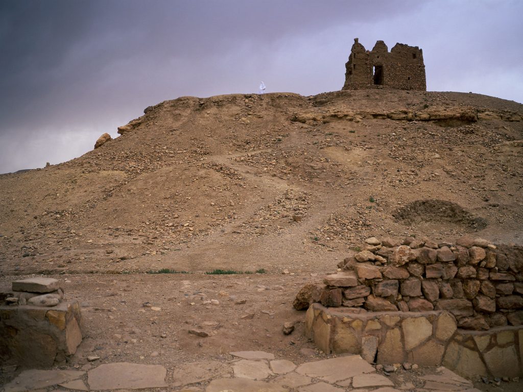 An ancient stone building perched atop a hill, exuding a sense of history and grandeur.