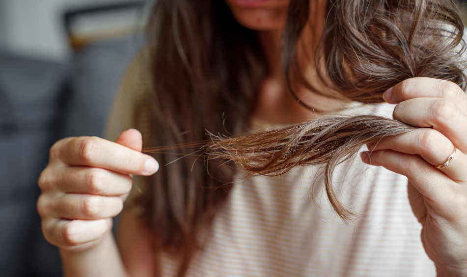 Women carefully watching her fizzy hairs