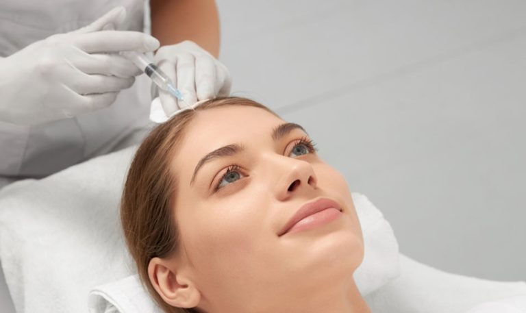 A healthcare worker injecting medicine in women scalp